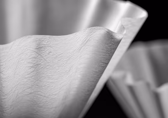 A close-up of a thick, bonded Chemex paper filter, showing its texture compared to a standard coffee filter.