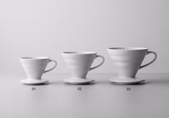Three Hario V60 drippers (size 01, 02, and 03) lined up to show the difference in scale.