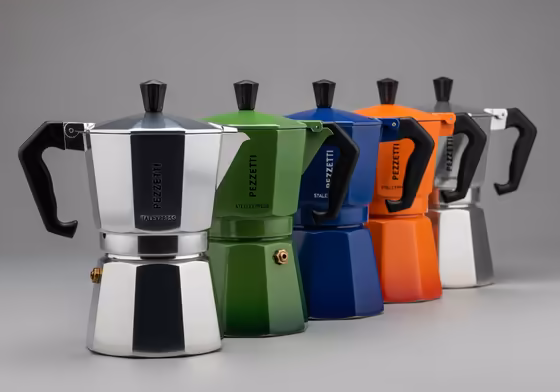 A lineup of colorful Pezzetti moka pots, showing both the aluminum Italexpress and stainless steel Steelexpress models.