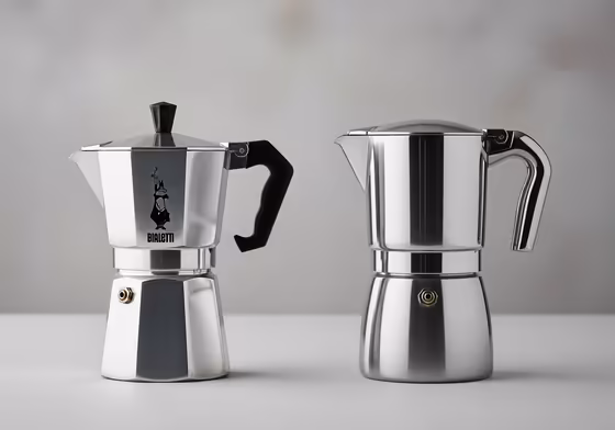 Side-by-side comparison of a classic aluminum Bialetti Moka Express and a modern stainless steel moka pot.